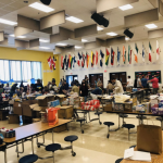 Scouts in Washington D.C. and adults take over a huge room to sort, pack, and seal heaps of supplies to make Pocket First Aid Kits