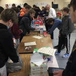 Scouts in Philadelphia pay close attention to ensure the Pocket First Aid Kits are stuffed and sealed properly